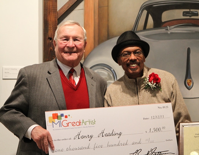 Oakland County Executive L. Brook Patterson presents last year's winner Henry Heading with a check. Contest winners and runners up have the opportunity for a multitude of prizes including expert framing, exhibitions of their artwork and small business classes. 