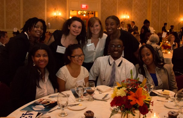 Park West Foundation director Saba Gebrai (top row, right) poses with youth affiliated the foundation's work to help local children aging out of foster care.