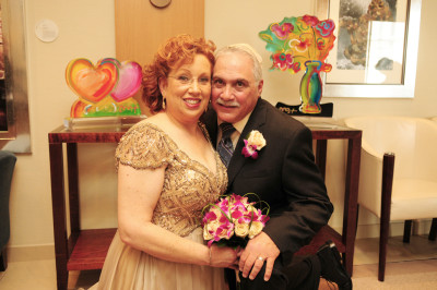 Randi and Mark posing with sculptures by Peter Max