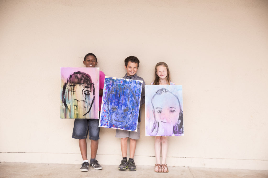 Students at Barton Elementary show off their student portraits. (Photo courtesy of Doug de Forest)
