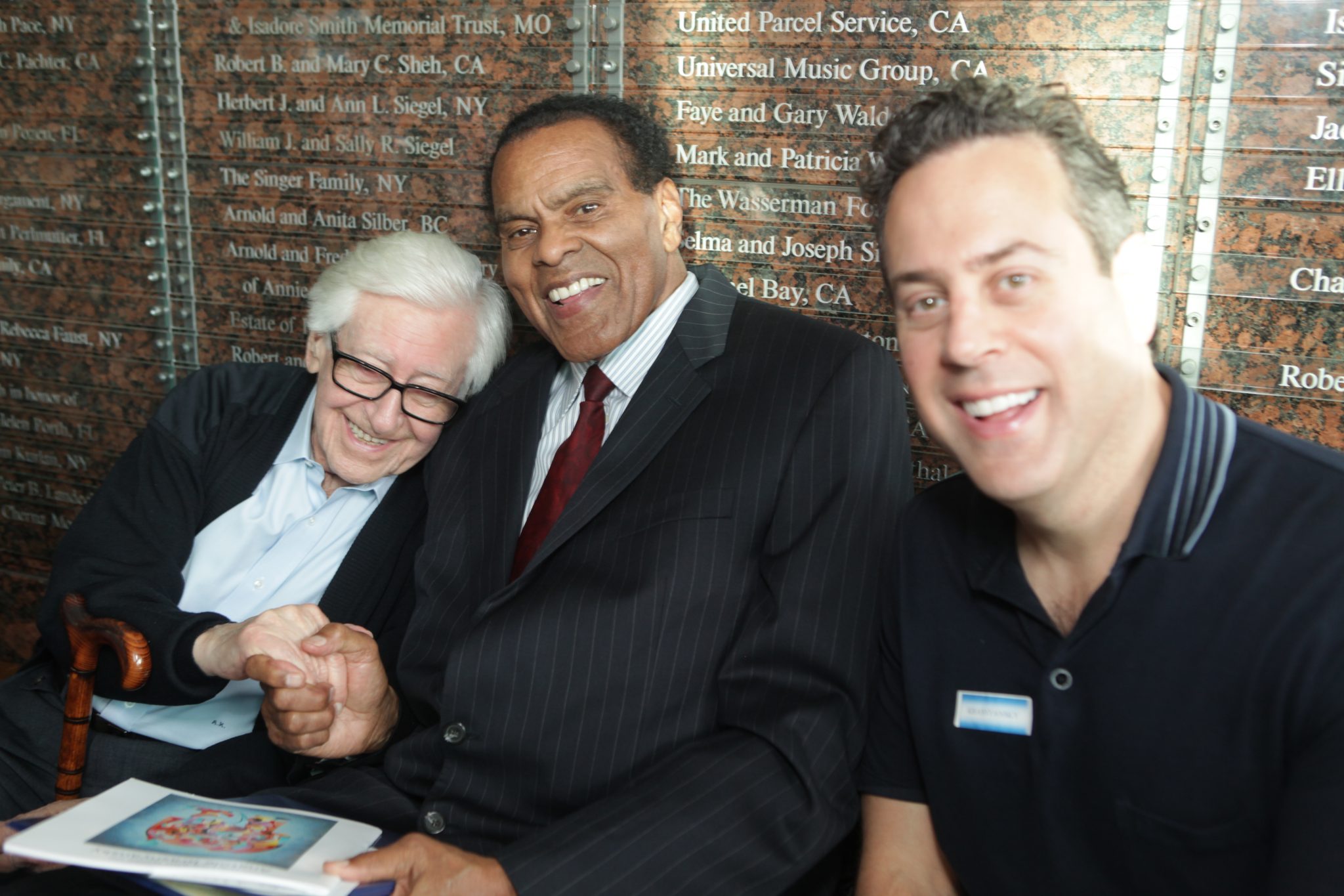 Anatole Krasnyansky shakes hands with former NBA star Tommy Hawkins at Museum of Tolerance.