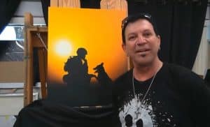 Michael Godard shows telecast viewers a new painting he's working on inspired by Dogs to Dog Tags