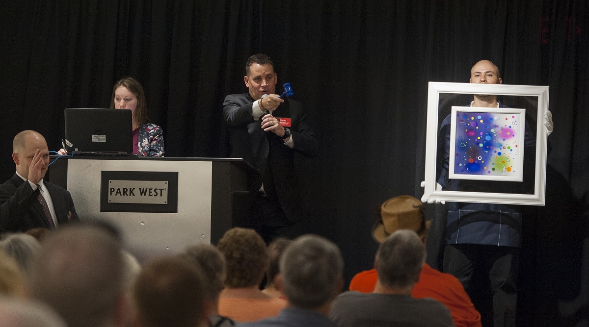 VIP auctioneer Jason Betteridge auctions off a Yaacov Agam work at the opening of the renovated Park West Museum, 2017, "Year of Art."