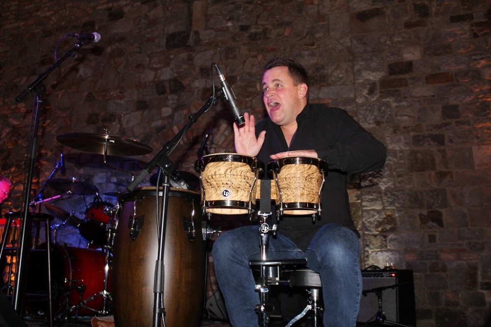 VIP auctioneer Jason Betteridge playing bongos with Gary Puckett and the New Union Gap