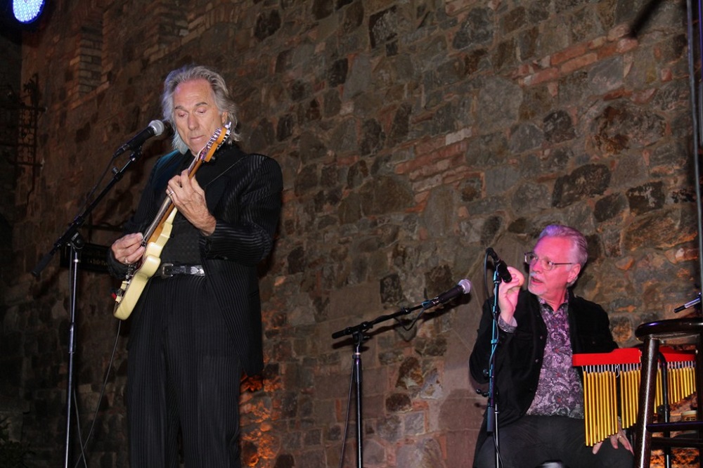 Gary Puckett playing at a Park West event, accompanied by Park West Gallery Director Morris Shapiro