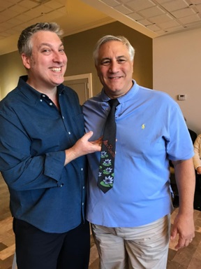 Artist Alexandre Renoir (left) created a one-of-a-kind hand-painted tie for Steve Miller (right) during one of their VIP art cruises.