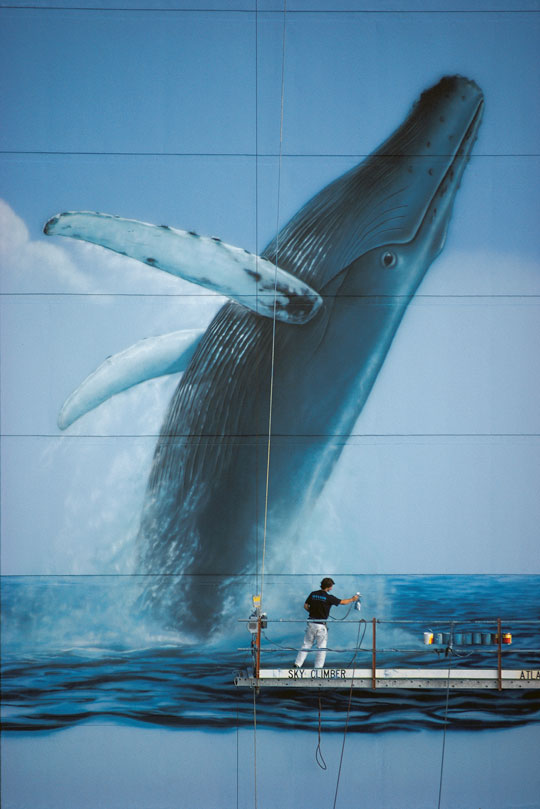 Wyland working on his sixth "Whaling Wall" mural, “Hawaiian Humpbacks." It was originally dedicated in Honolulu, Hawaii in 1985. (Image courtesy of the Wyland Foundation)