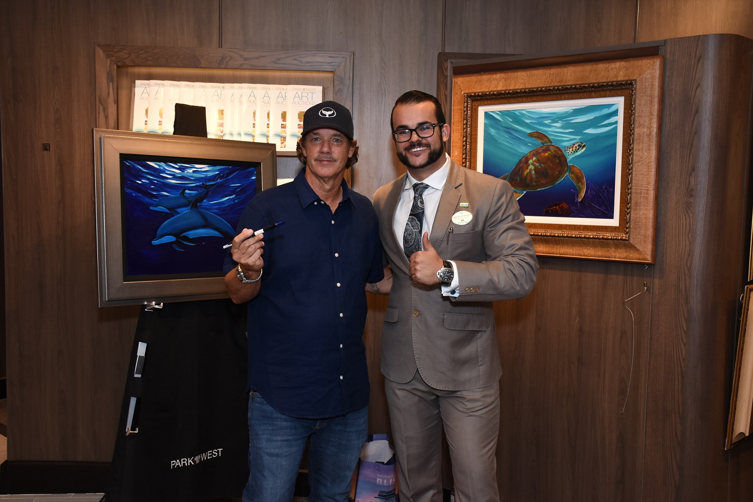 Wyland and Chris Vounnou from Park West on Norwegian Bliss