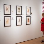 A guest considers Dalí’s take on Dante's "Divine Comedy" at the Hilliard Art Museum's opening for “Salvador Dalí’s Stairway to Heaven.”