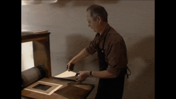 How Etchings Are Made: Dampened paper is placed over the plate and put through a printing press.