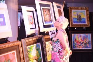 Guest browses Celebrity Edge's art collection.