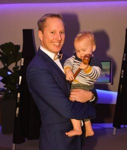Auctioneer Deon van der Merwe teaches his son how to use a gavel on Celebrity Edge.
