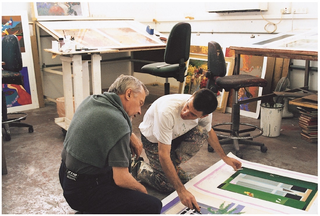 Artist Igor Medvedev checking the colors on an in-progress serigraph in his studio.