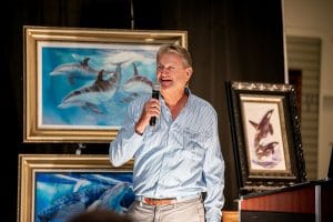 Guy Harvey talks to a crowd of Park West auctioneers.