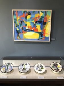 "The Meadow (La Clairiére; 1960), Marcel Mouly, hanging above a selection of Picasso's ceramic works