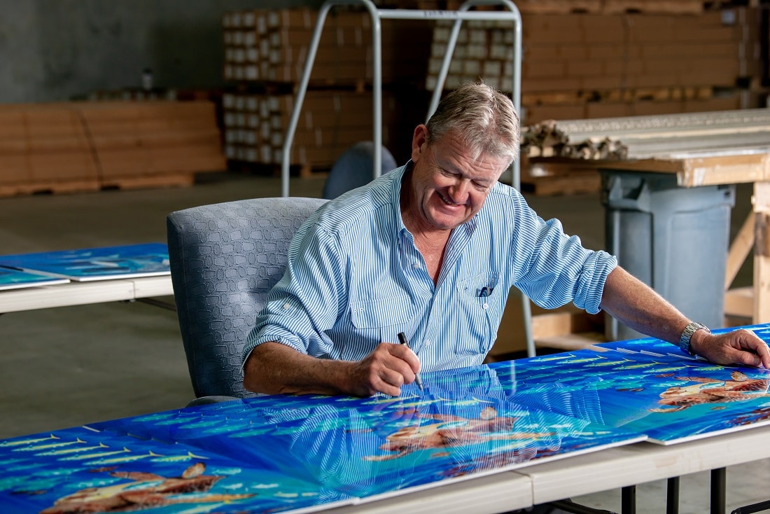 Harvey signing his artwork at Park West Gallery Miami.