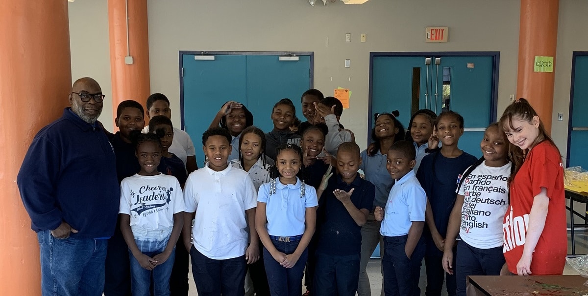 Autumn de Forest poses with one of her art classes at the Detroit Academy of Arts & Sciences 