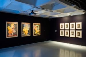 Toulouse-Lautrec's "Miss Loïe Fuller" lithographs share gallery space at the Barbican with other posters promoting Fuller's elaborate performances. Photo credit © Max Colson
