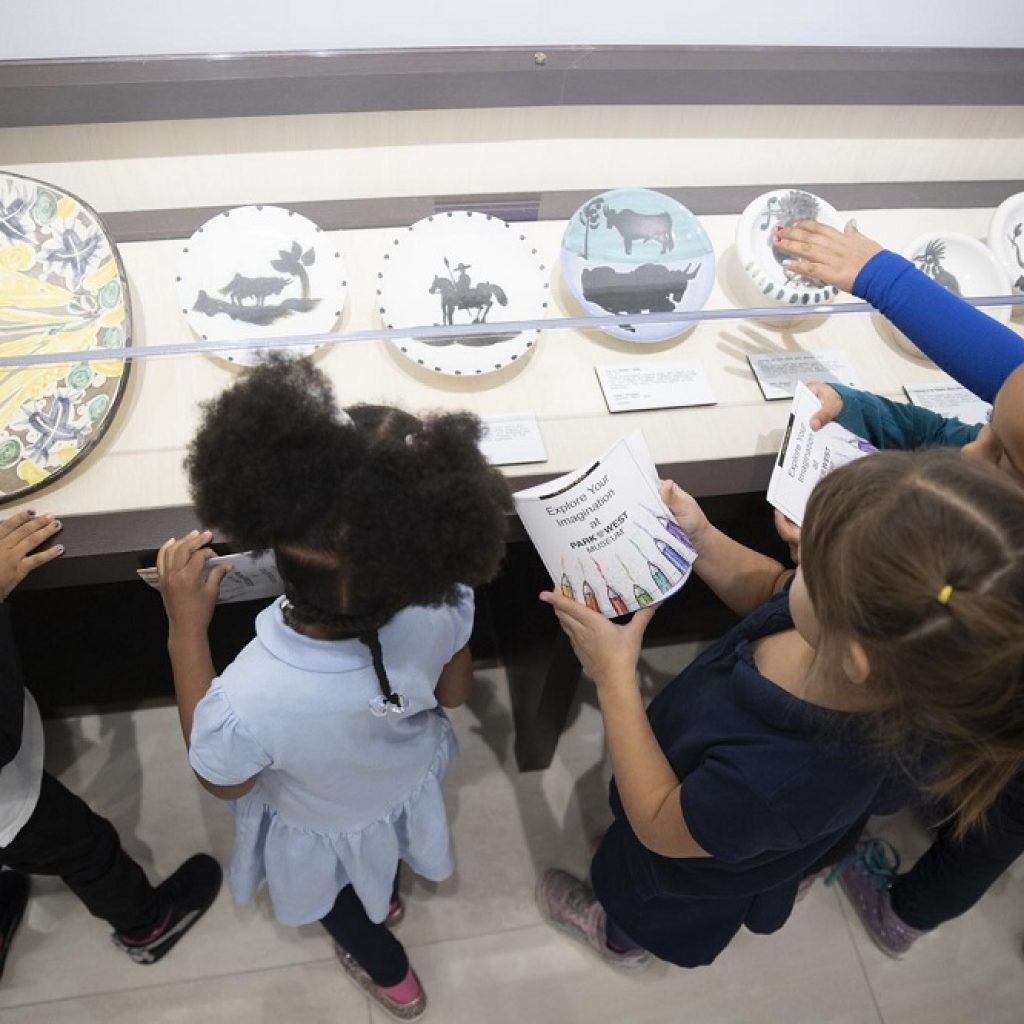 Local schoolchildren on a field trip enjoy Park West's collection of Picasso ceramics.