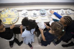 Local schoolchildren on a field trip enjoy Park West's collection of Picasso ceramics.