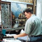 Thomas Kinkade working on his acclaimed painting "Mountain Chapel"