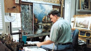 Thomas Kinkade working on his acclaimed painting "Mountain Chapel"