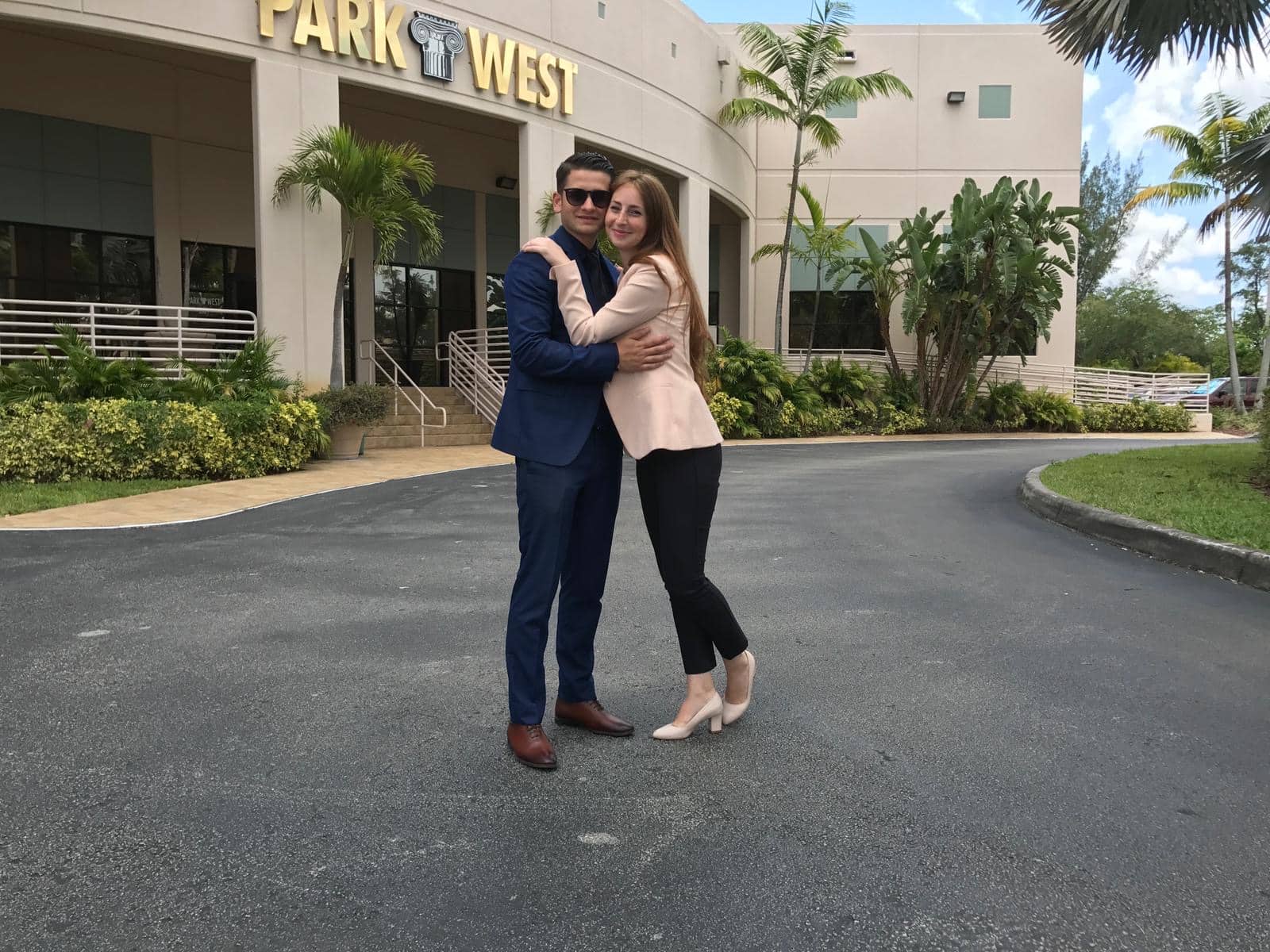 Park West Gallery Auctioneers Sergiu Miron and Alexandra Dima in front of Park West's Miami Lakes location