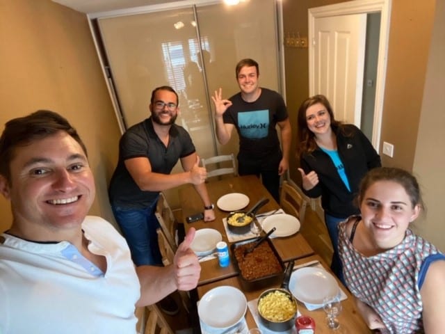 The group enjoys a dinner at their London rental home.