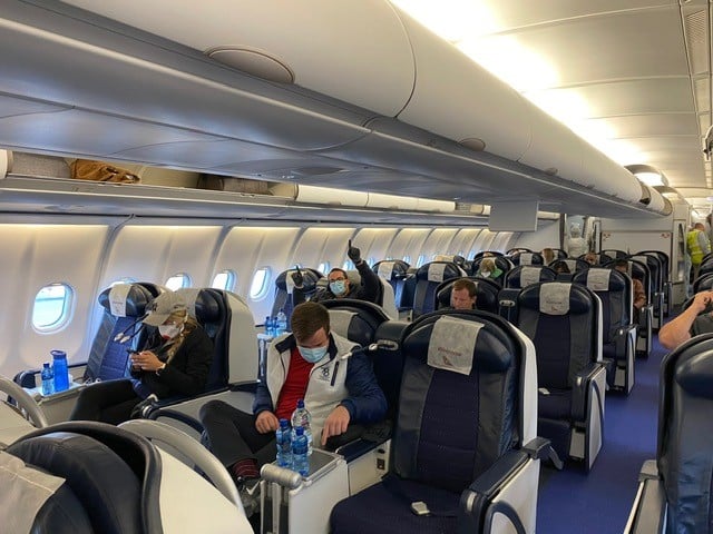 Christopher Vounnou, in particular, looks excited to be on his flight home to South Africa.