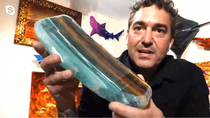 Cris X holds a piece of his "Sculpture Abstraction" after it has been sanded down