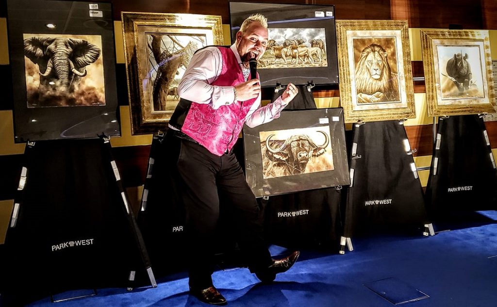 Lloyd turns it on while presenting the art of Andrew Bone at one of his shipboard art auctions.