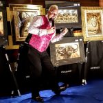 Lloyd turns it on while presenting the art of Andrew Bone at one of his shipboard art auctions.