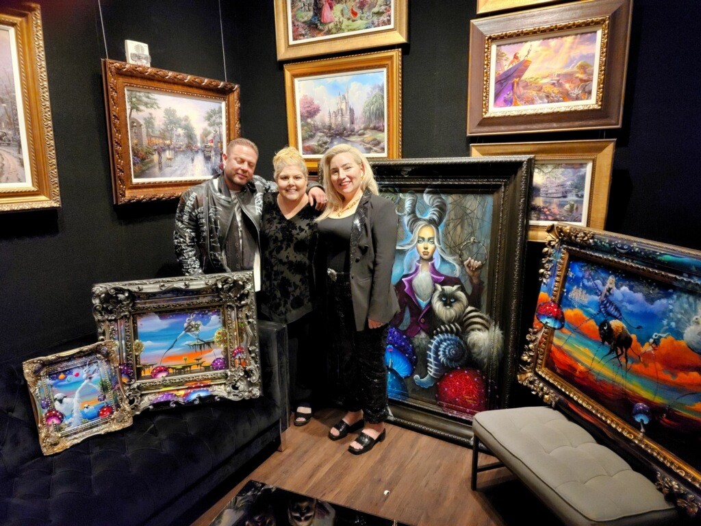 Kat Tatz (center) poses with collectors at her Park West exhibition party