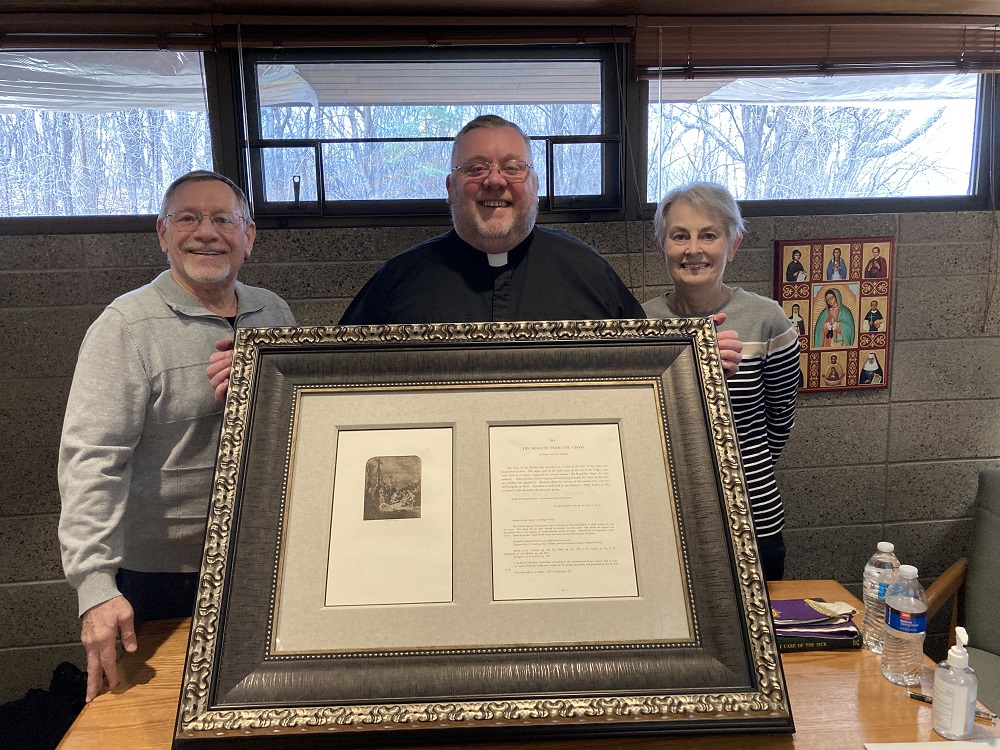 Scott and Terry Jurek present “The Descent from the Cross” to Fr. Tony O’Neill at St. John Neumann in Minnesota