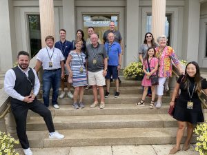 Principal Auctioneer Jason Betteridge (left) poses with a group of Tim Yanke collectors about to take a VIP tour of the Park West Museum.